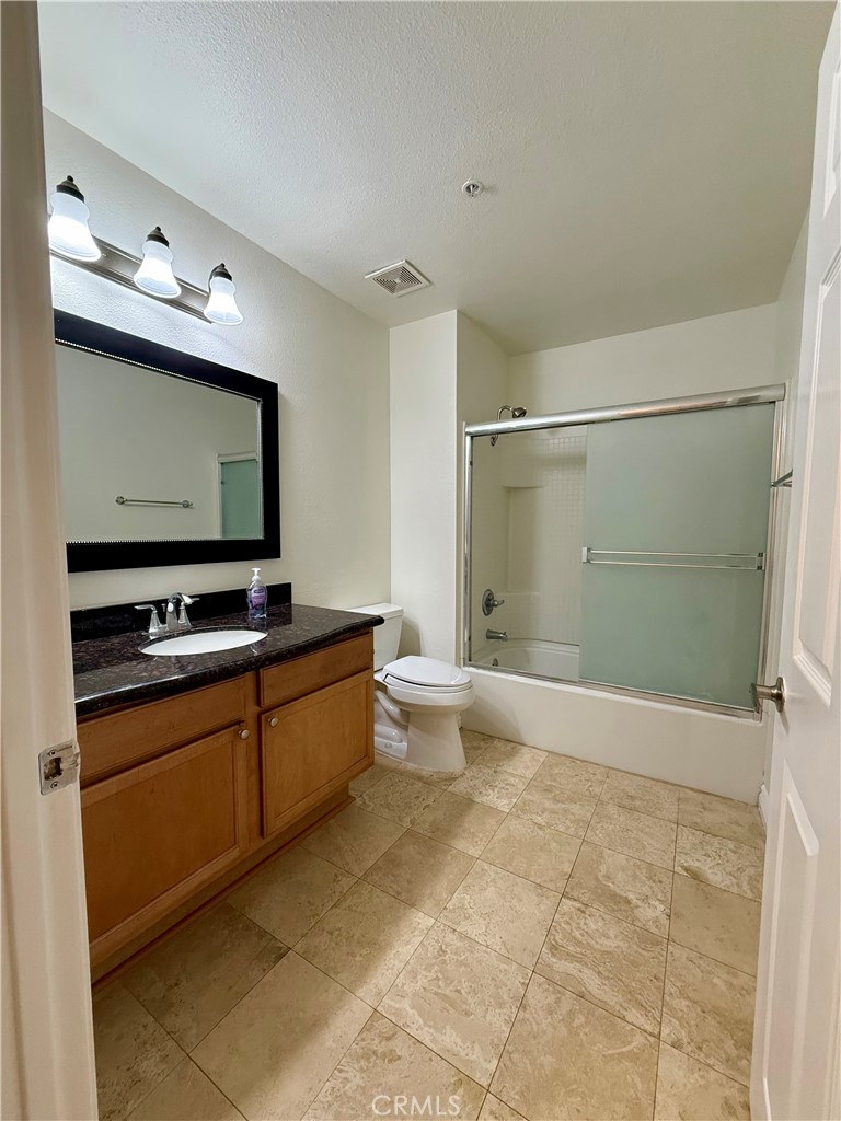 375 Central Avenue, Unit 113 Riverside, CA 92507 - Photo 7 of 19 a bathroom with a double vanity sink toilet and mirror
