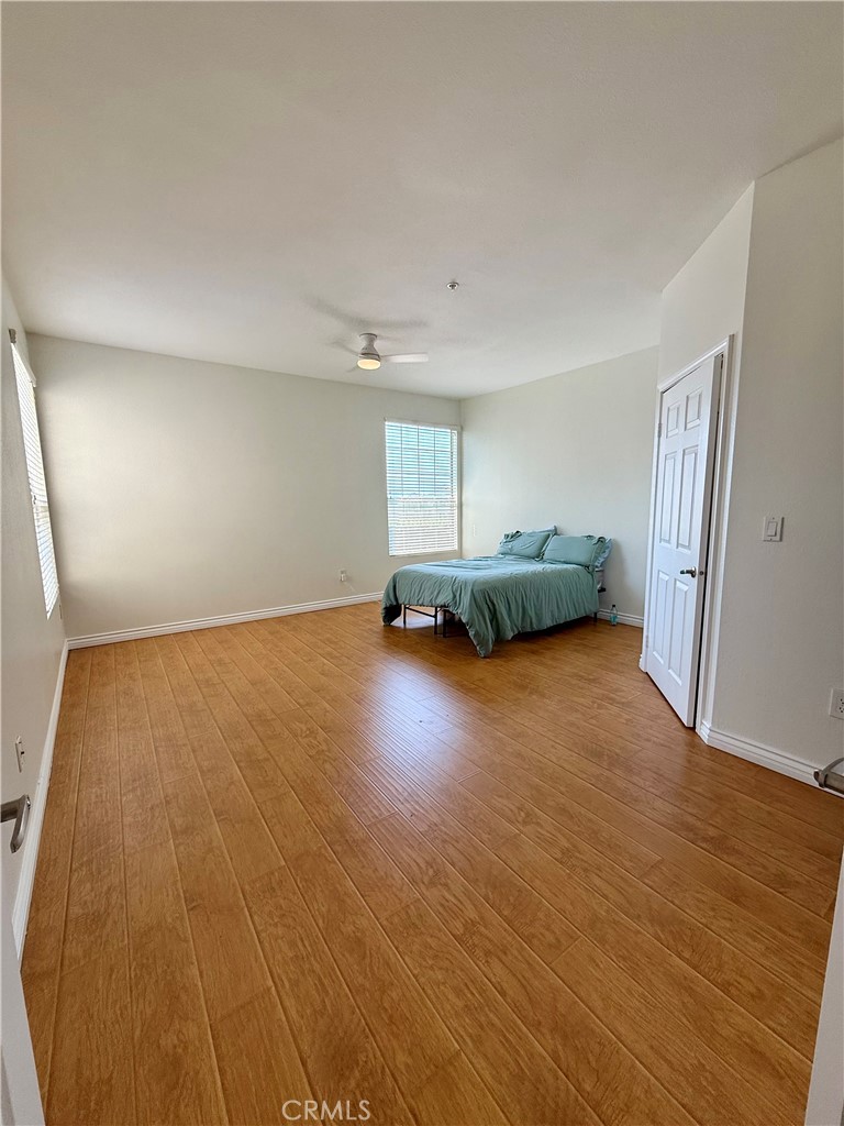 375 Central Avenue, Unit 113 Riverside, CA 92507 - Photo 10 of 19 an empty room with a fireplace and wooden floor