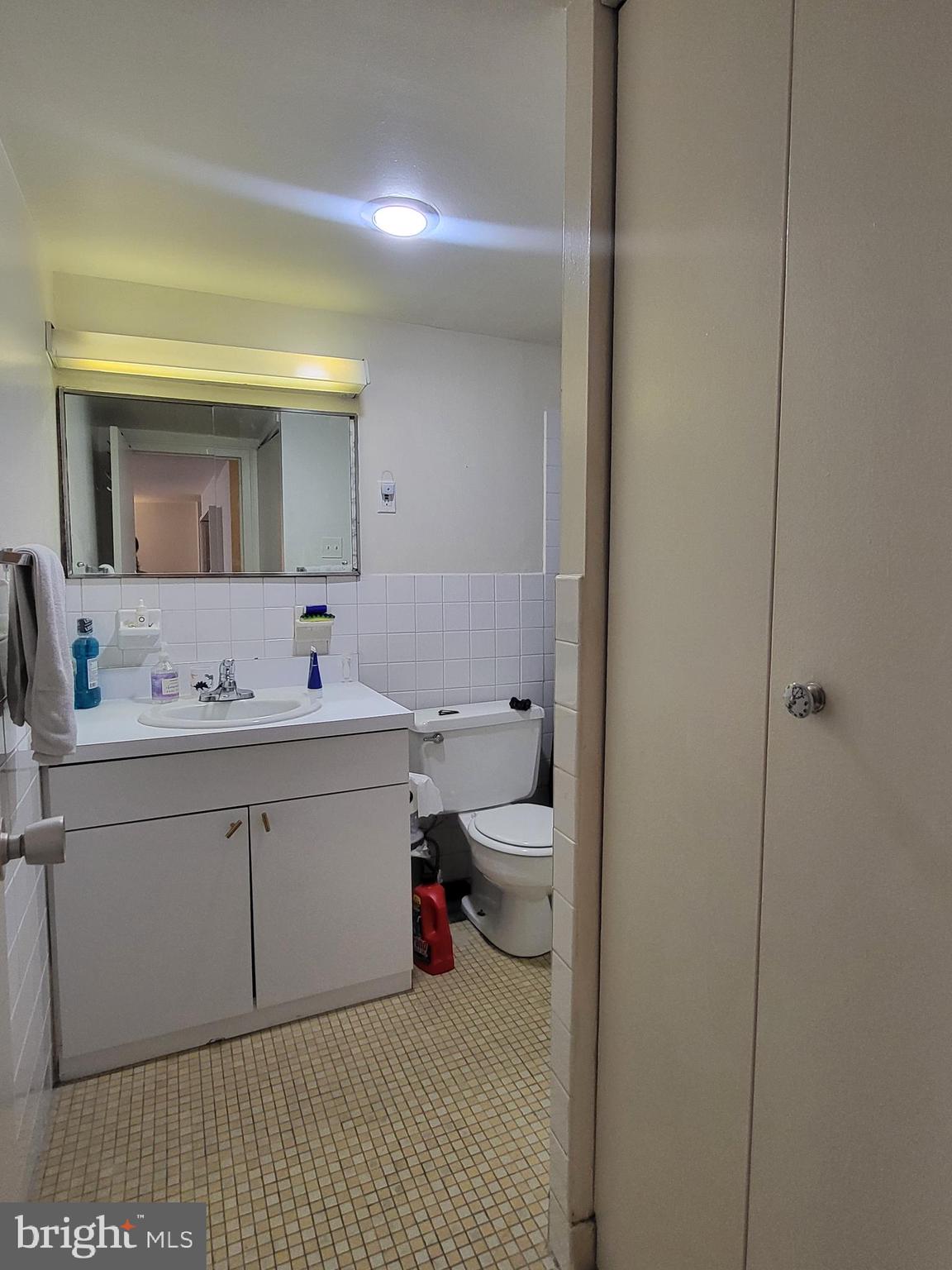 224 West Rittenhouse Square, Unit 413 Philadelphia, PA 19103 - Photo 11 of 25 a bathroom with a sink vanity and mirror