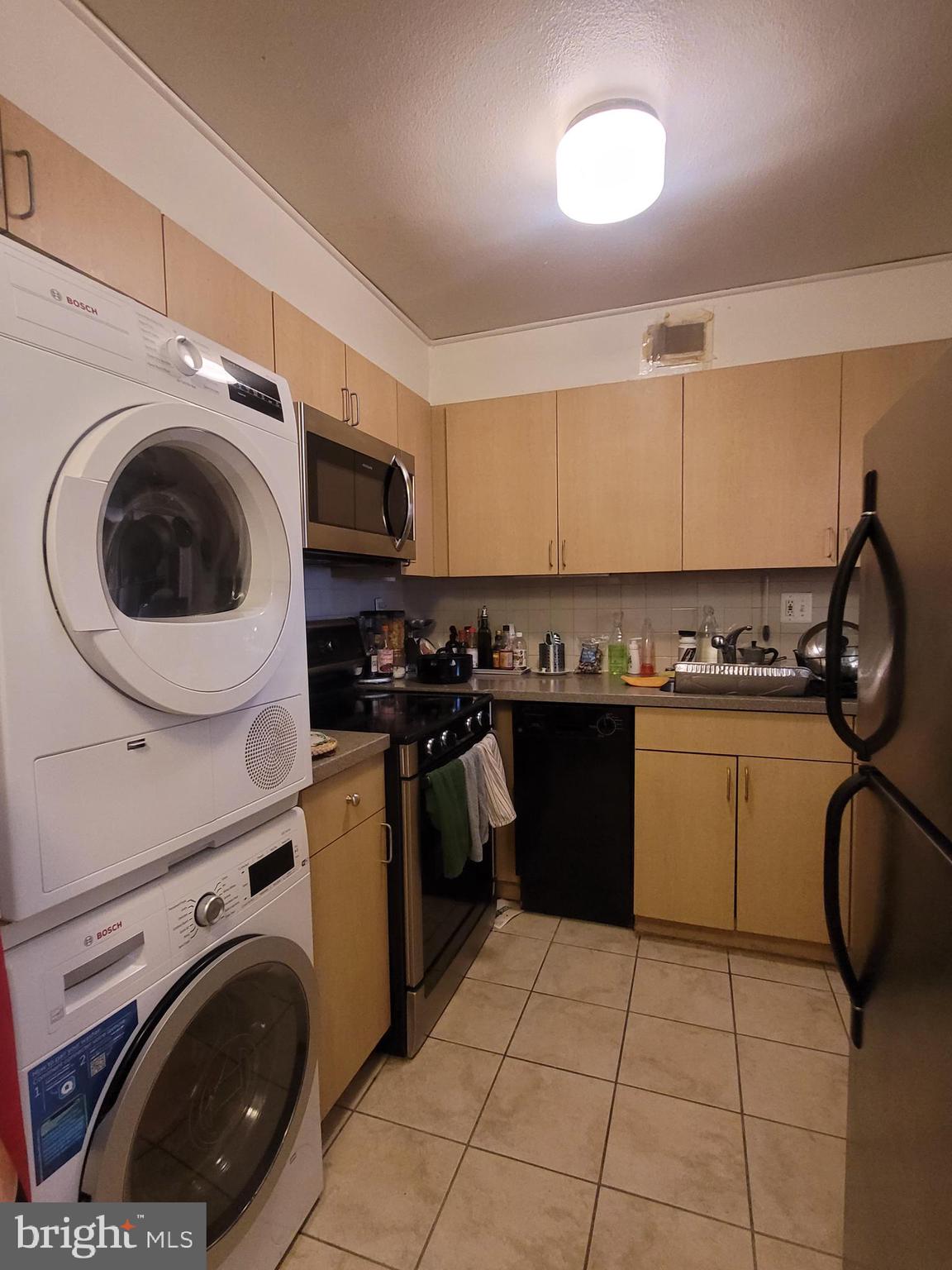 224 West Rittenhouse Square, Unit 413 Philadelphia, PA 19103 - Photo 4 of 25 a kitchen with a stove a sink and a washer dryer