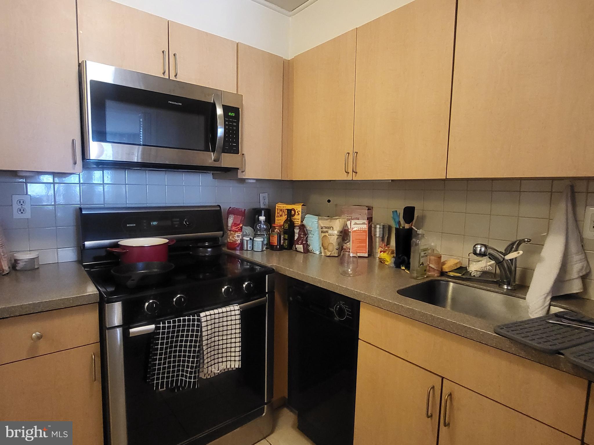 224 West Rittenhouse Square, Unit 413 Philadelphia, PA 19103 - Photo 6 of 25 a kitchen with a sink a stove and cabinets