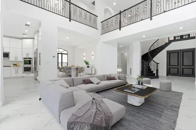 a large kitchen with kitchen island granite countertop a stove a sink a dining table and chairs