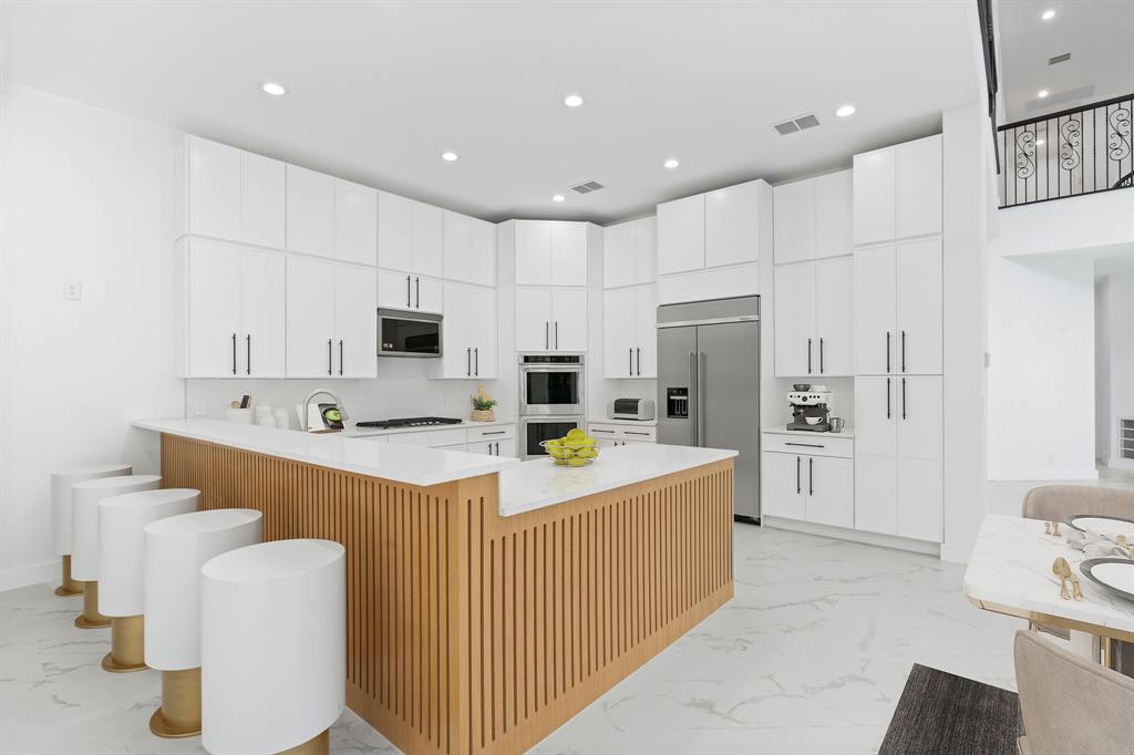 17935 Monte Vista Drive Boca Raton, FL 33496 - Photo 16 of 60 a kitchen with kitchen island a white counter top space cabinets and stainless steel appliances
