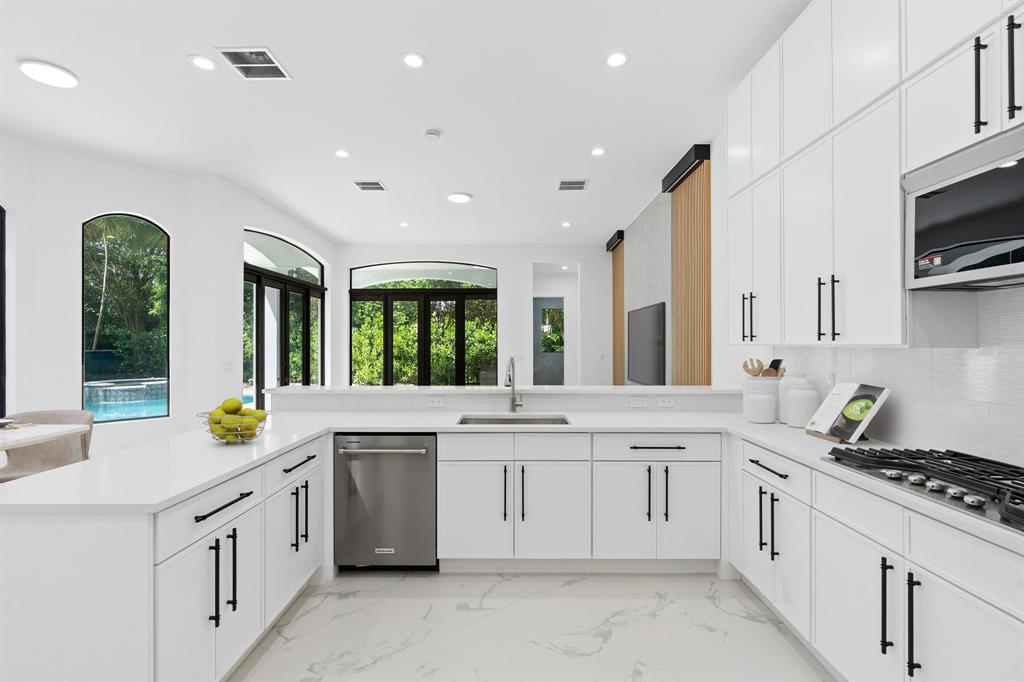17935 Monte Vista Drive Boca Raton, FL 33496 - Photo 19 of 60 a kitchen with white cabinets and appliances