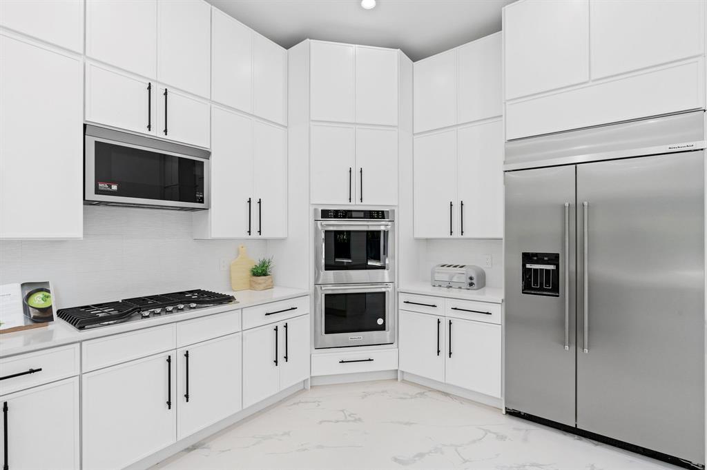 17935 Monte Vista Drive Boca Raton, FL 33496 - Photo 20 of 60 a kitchen with stainless steel appliances white cabinets and white appliances