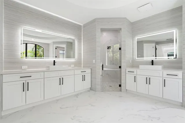 a bathroom with a granite countertop sink a toilet and a mirror