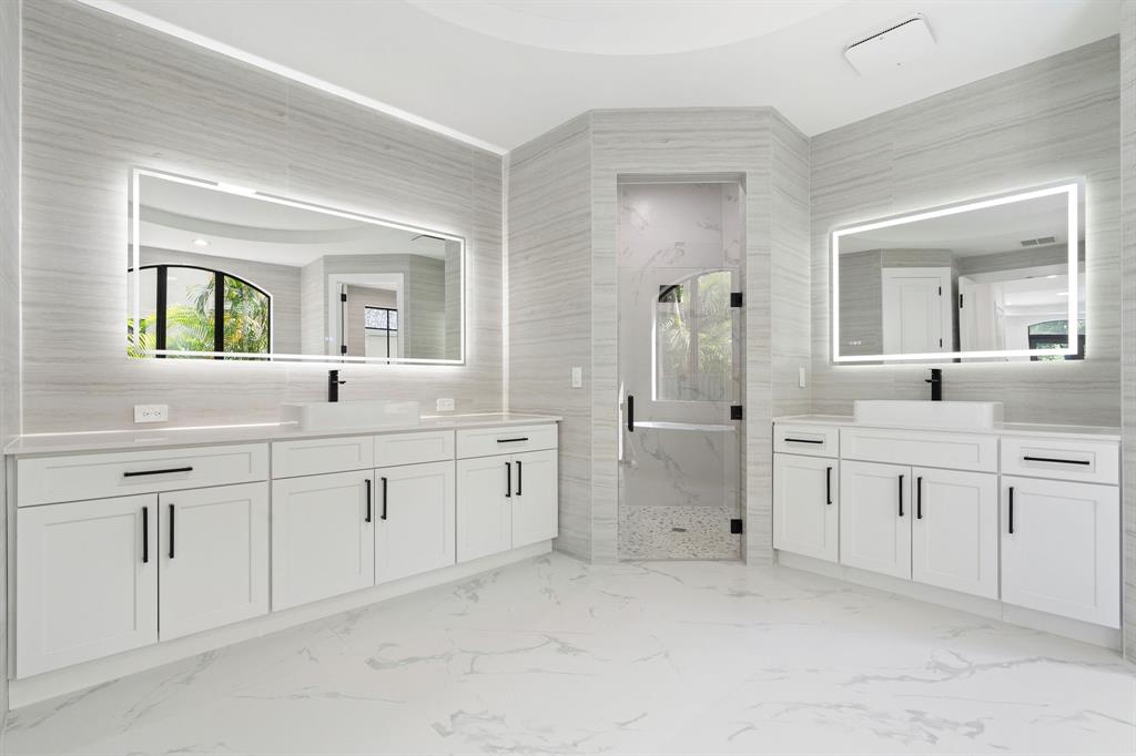 17935 Monte Vista Drive Boca Raton, FL 33496 - Photo 32 of 60 a spacious bathroom with a granite countertop sink mirror and bathtub