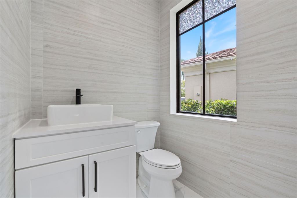 17935 Monte Vista Drive Boca Raton, FL 33496 - Photo 33 of 60 a bathroom with a toilet a sink and a window