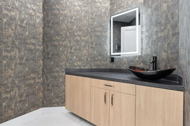 a bathroom with a double vanity sink and mirror