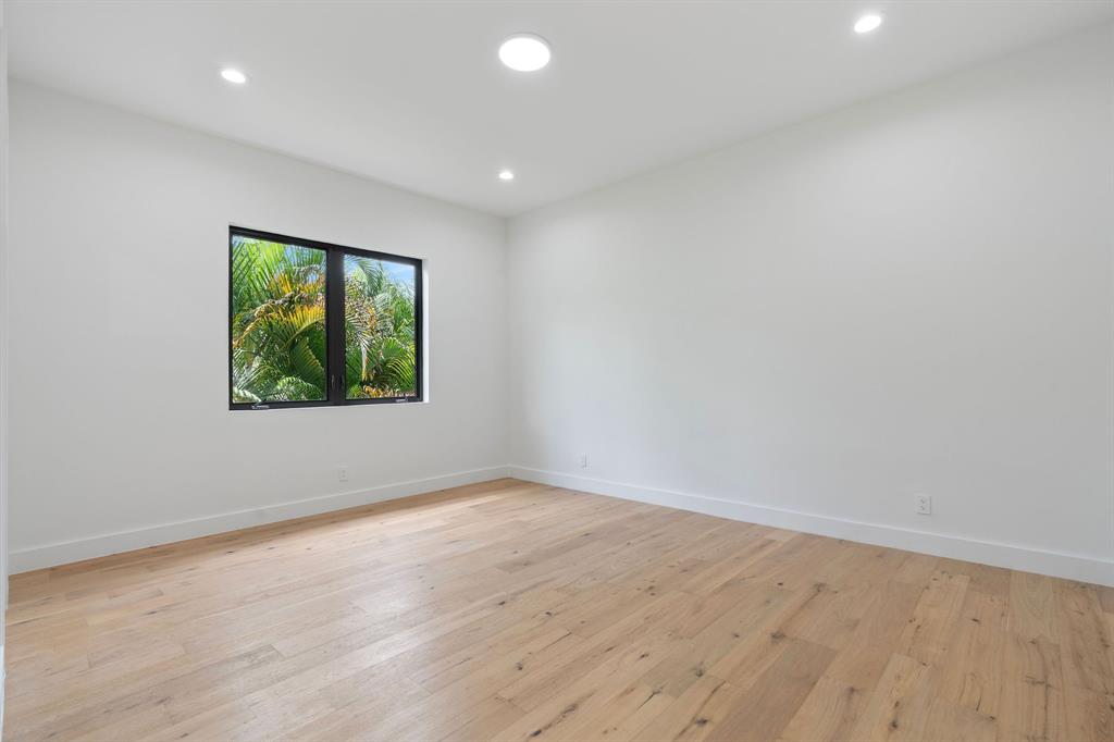 17935 Monte Vista Drive Boca Raton, FL 33496 - Photo 43 of 60 an empty room with wooden floor and windows