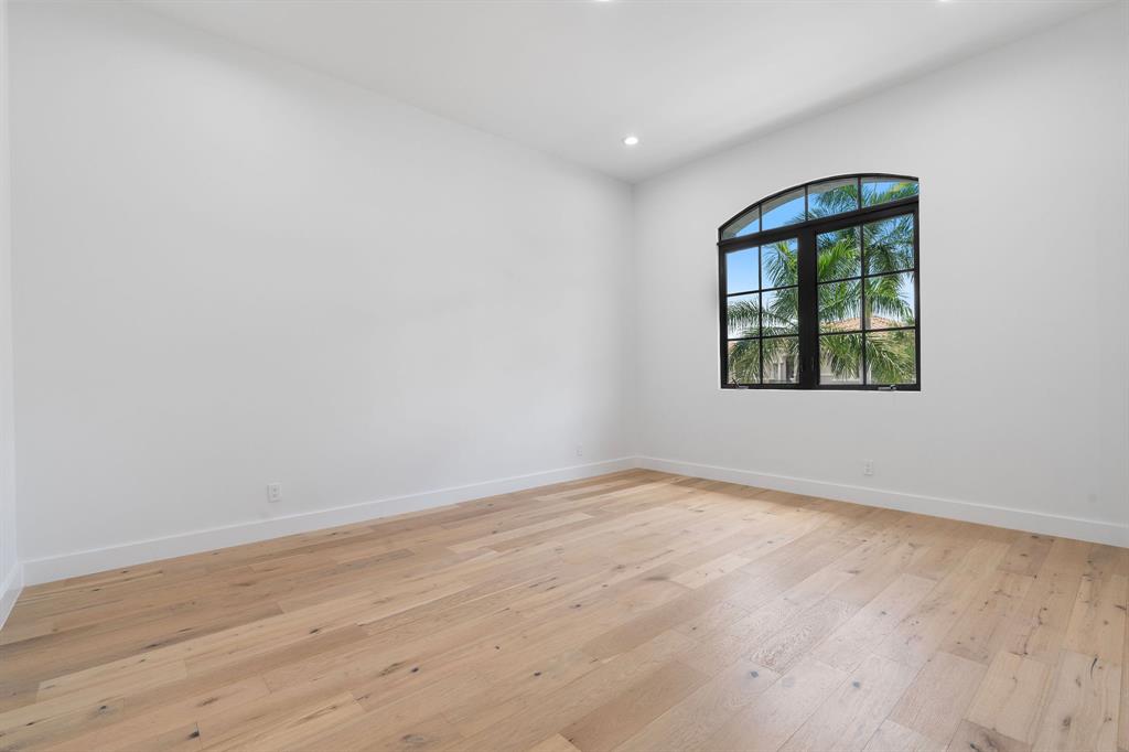 17935 Monte Vista Drive Boca Raton, FL 33496 - Photo 44 of 60 an empty room with wooden floor and windows