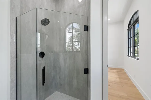 a bathroom with a double vanity sink mirror and bathtub