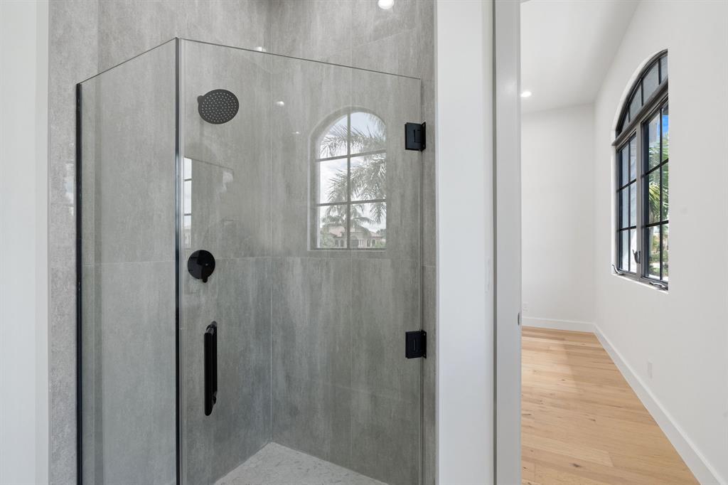 17935 Monte Vista Drive Boca Raton, FL 33496 - Photo 46 of 60 a bathroom with a mirror and a shower