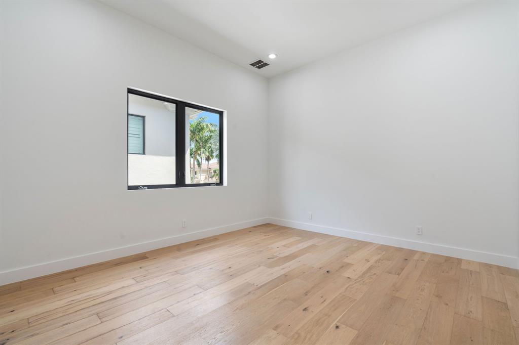 17935 Monte Vista Drive Boca Raton, FL 33496 - Photo 47 of 60 an empty room with wooden floor and windows