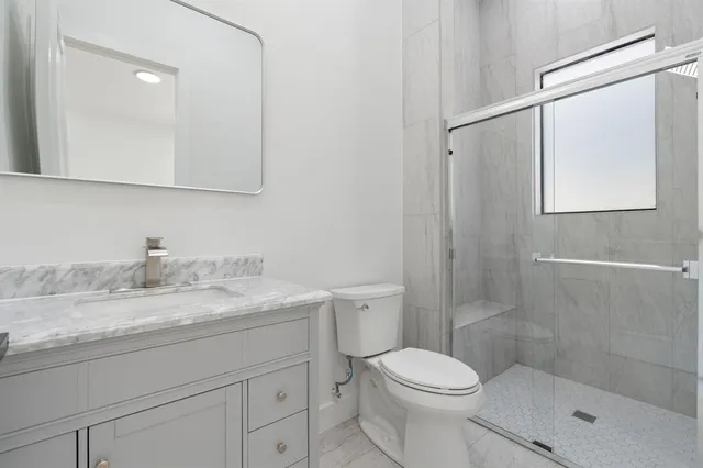 a backyard of a house with table and chairs under an umbrella
