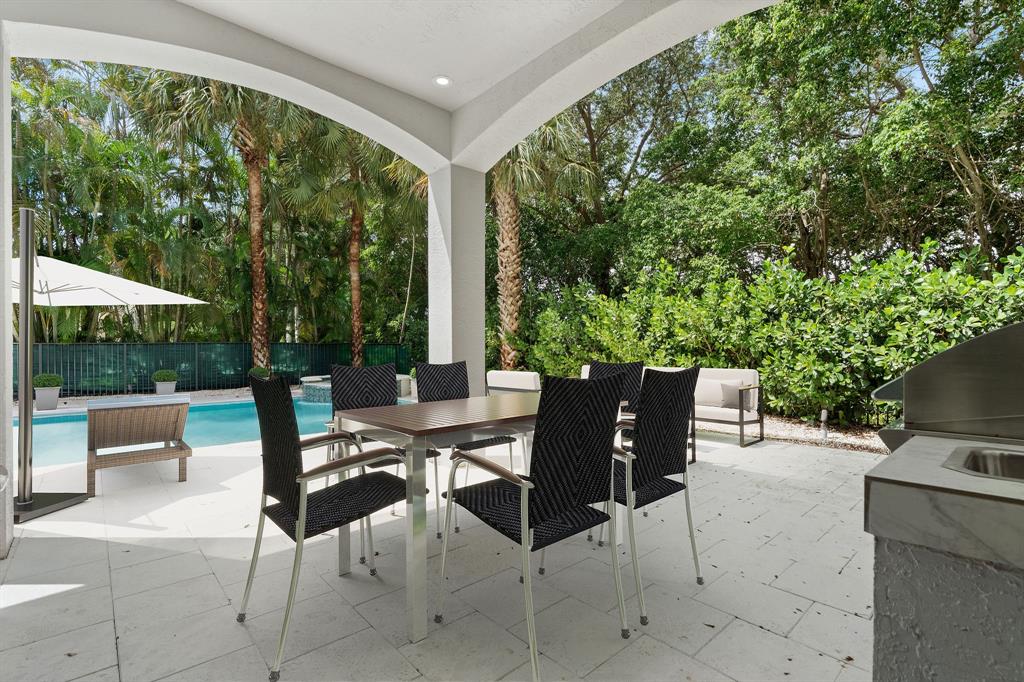 17935 Monte Vista Drive Boca Raton, FL 33496 - Photo 60 of 60 a view of a patio with a dining table and chairs with a small yard