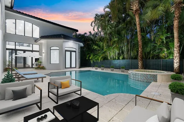 a view of a patio with couches and a table and chairs with garden view