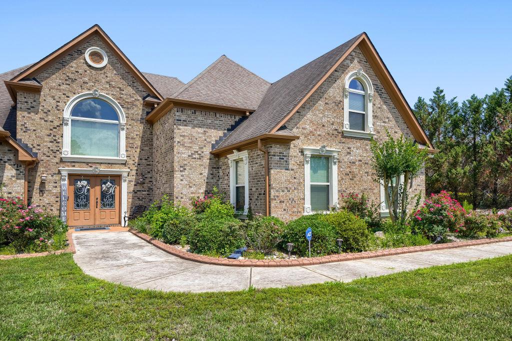 345 Masters Club Boulevard Hampton, GA 30228 - Photo 5 of 30 a front view of a house with a yard