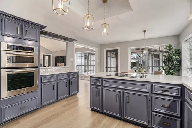 a kitchen with stainless steel appliances granite countertop a stove and cabinets