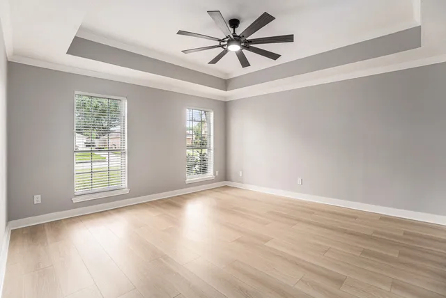 wooden floor in an empty room with a window
