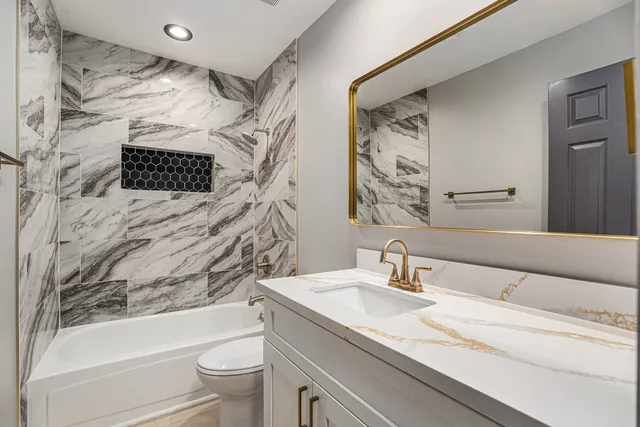 a bathroom with a sink a toilet and a bathtub