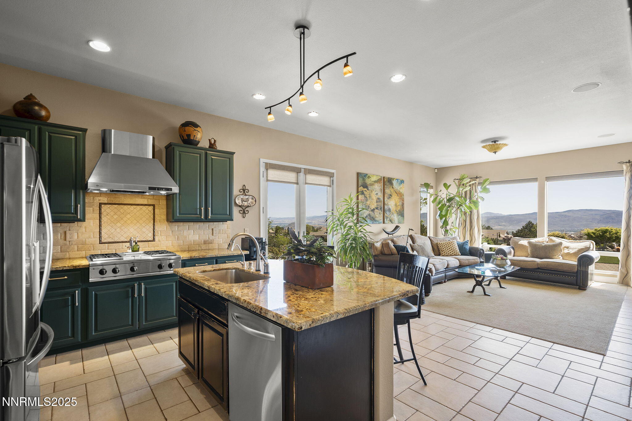 2698 Wind Feather Trail Reno, NV 89511 - Photo 11 of 44 a kitchen with counter top space a sink appliances and cabinets