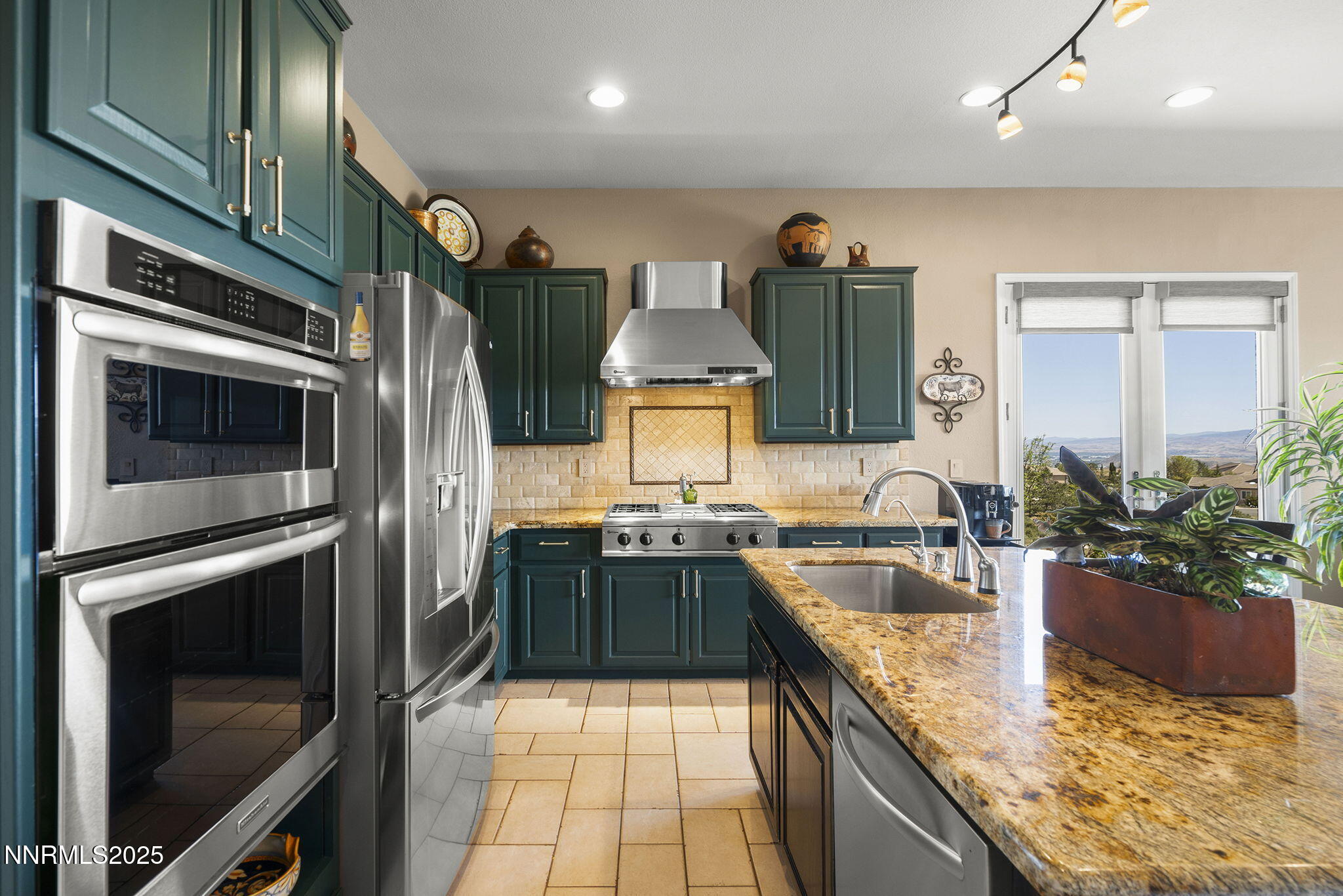 2698 Wind Feather Trail Reno, NV 89511 - Photo 12 of 44 a kitchen with stainless steel appliances granite countertop a sink stove and refrigerator