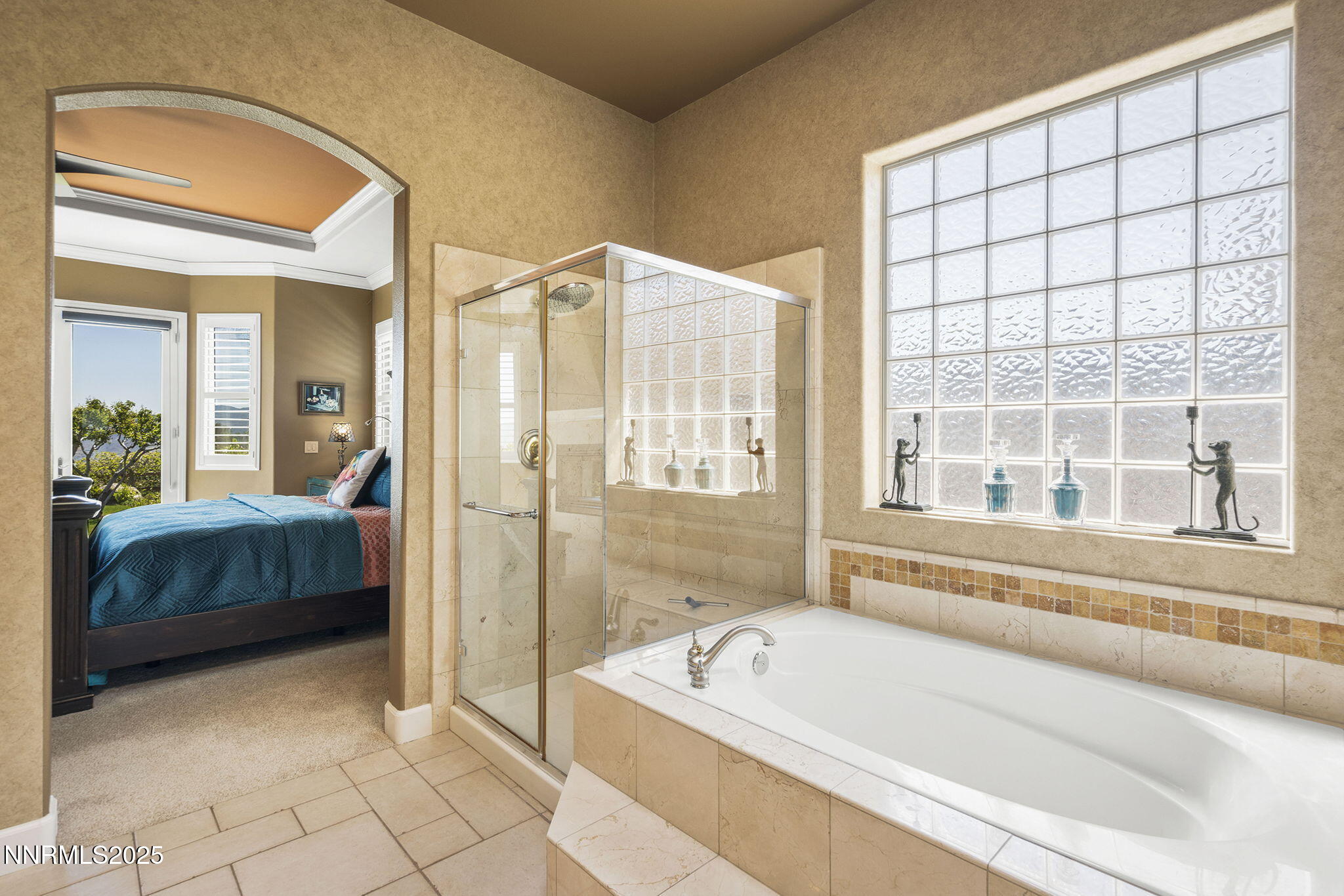 2698 Wind Feather Trail Reno, NV 89511 - Photo 20 of 44 a bathroom with a tub a sink and a large mirror next to a window