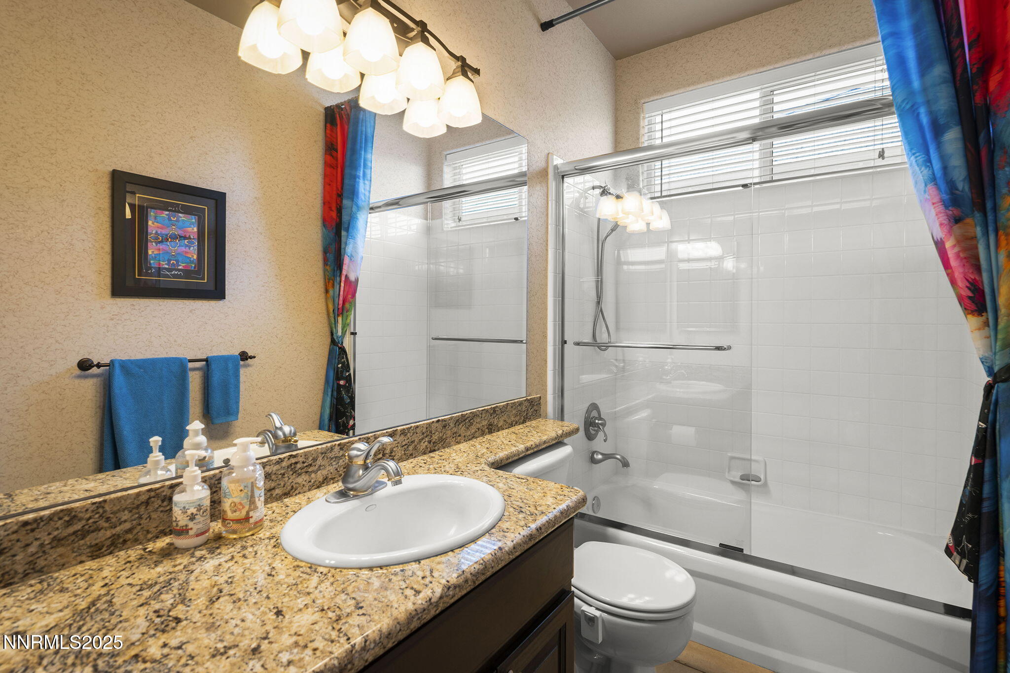 2698 Wind Feather Trail Reno, NV 89511 - Photo 23 of 44 a bathroom with a granite countertop sink toilet a mirror and shower