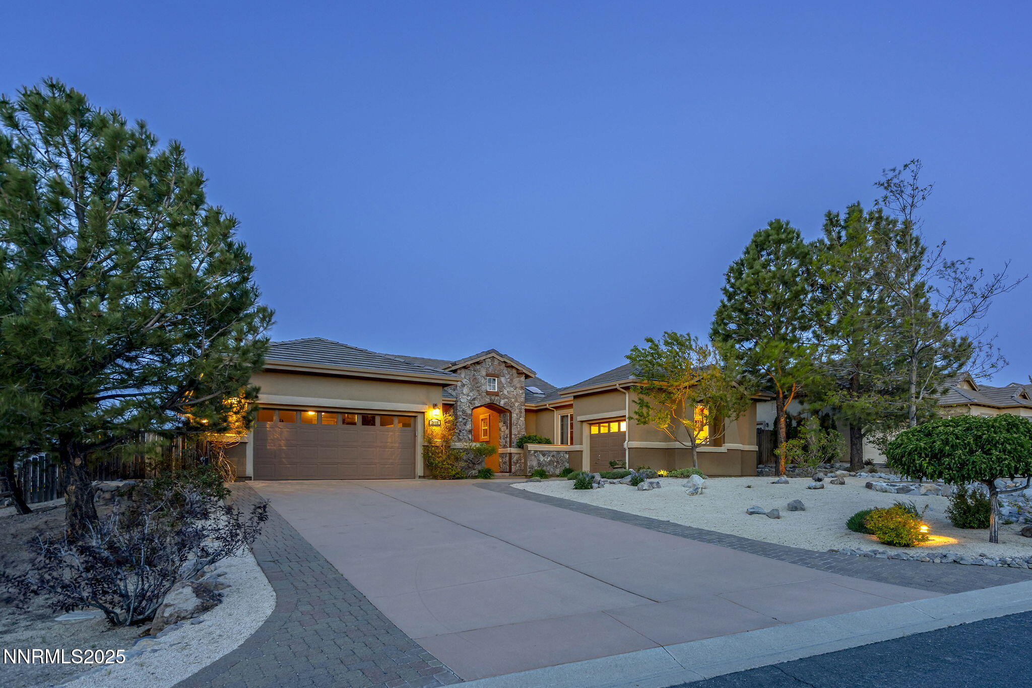 2698 Wind Feather Trail Reno, NV 89511 - Photo 26 of 44 a front view of a house with a yard and a garage