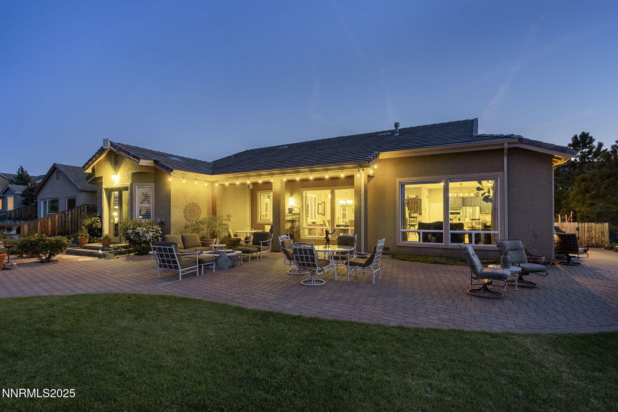 2698 Wind Feather Trail Reno, NV 89511 - Photo 28 of 44 a view of a patio with table and chairs under an umbrella with wooden floor