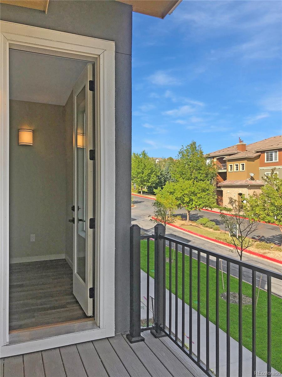 6767 South Tempe Court Aurora, CO 80016 - Photo 16 of 25 a view of a balcony with wooden floor
