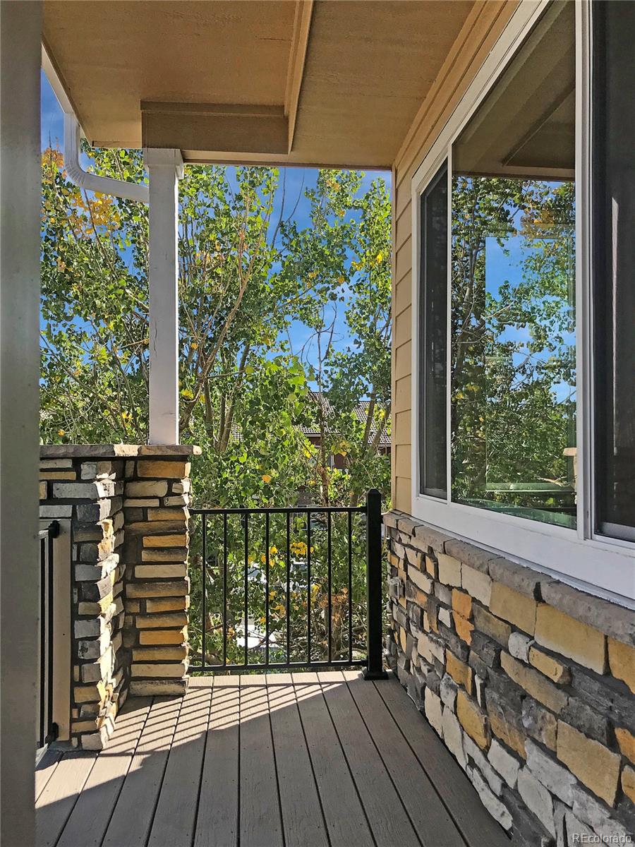 6767 South Tempe Court Aurora, CO 80016 - Photo 2 of 25 a view of a balcony with wooden floor