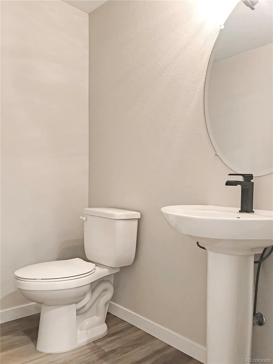 6767 South Tempe Court Aurora, CO 80016 - Photo 23 of 25 a white toilet sitting next to a bathroom sink