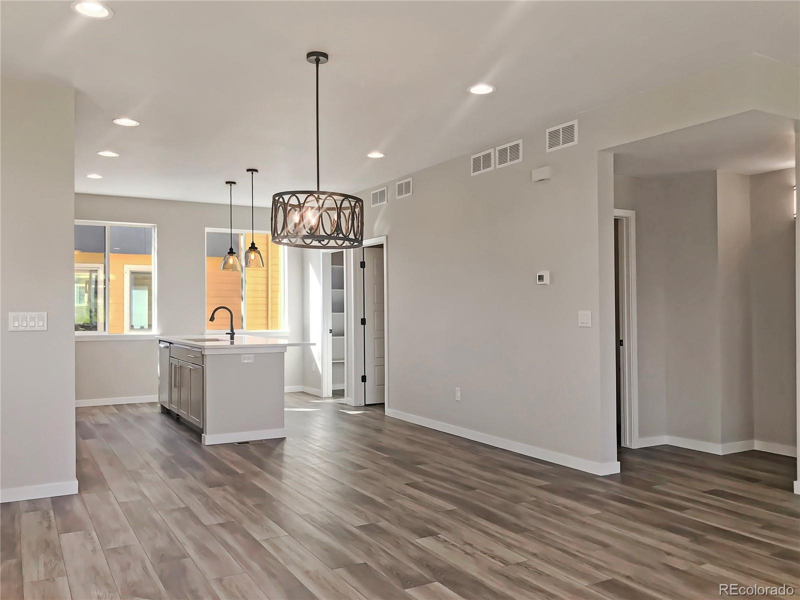 6767 South Tempe Court Aurora, CO 80016 - Photo 24 of 25 a view of kitchen and dining room with wooden floor