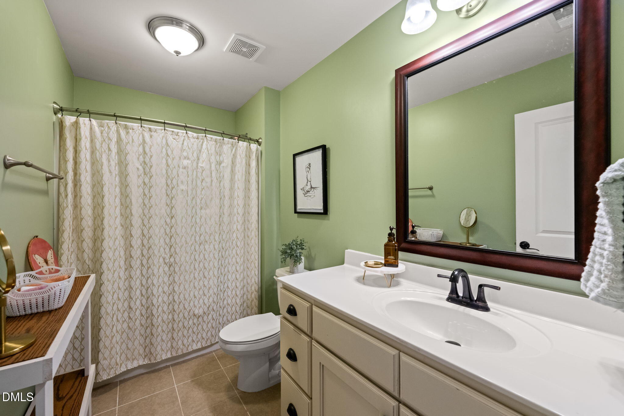 1716 Main Divide Drive Wake Forest, NC 27587 - Photo 26 of 45 a bathroom with a toilet a sink and a mirror