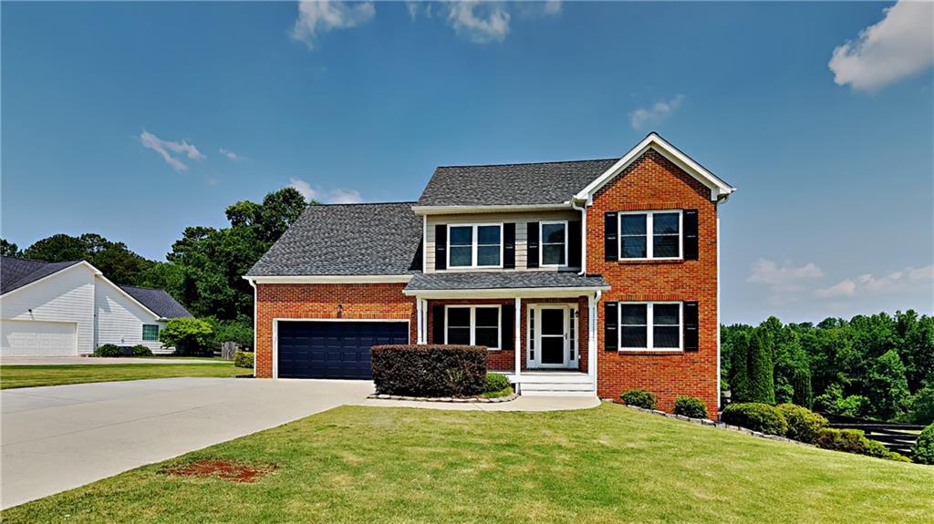 a front view of a house with a yard and garage