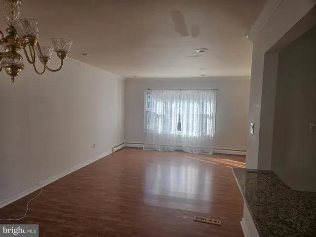 a view of room with window and wooden floor
