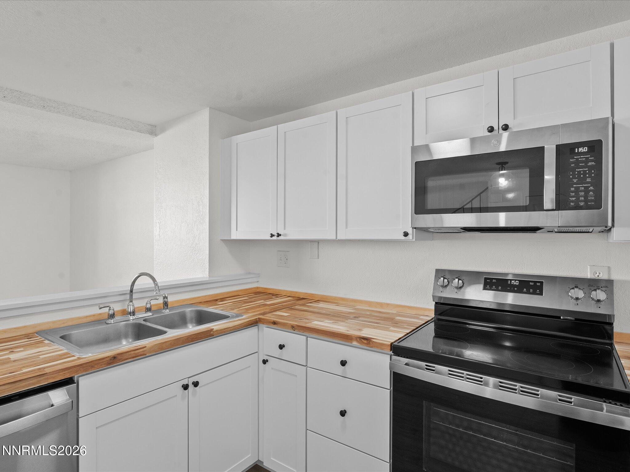 220 Allouette Way, Unit 4 Carson City, NV 89701 - Photo 12 of 22 a kitchen with stainless steel appliances granite countertop white cabinets a sink and dishwasher