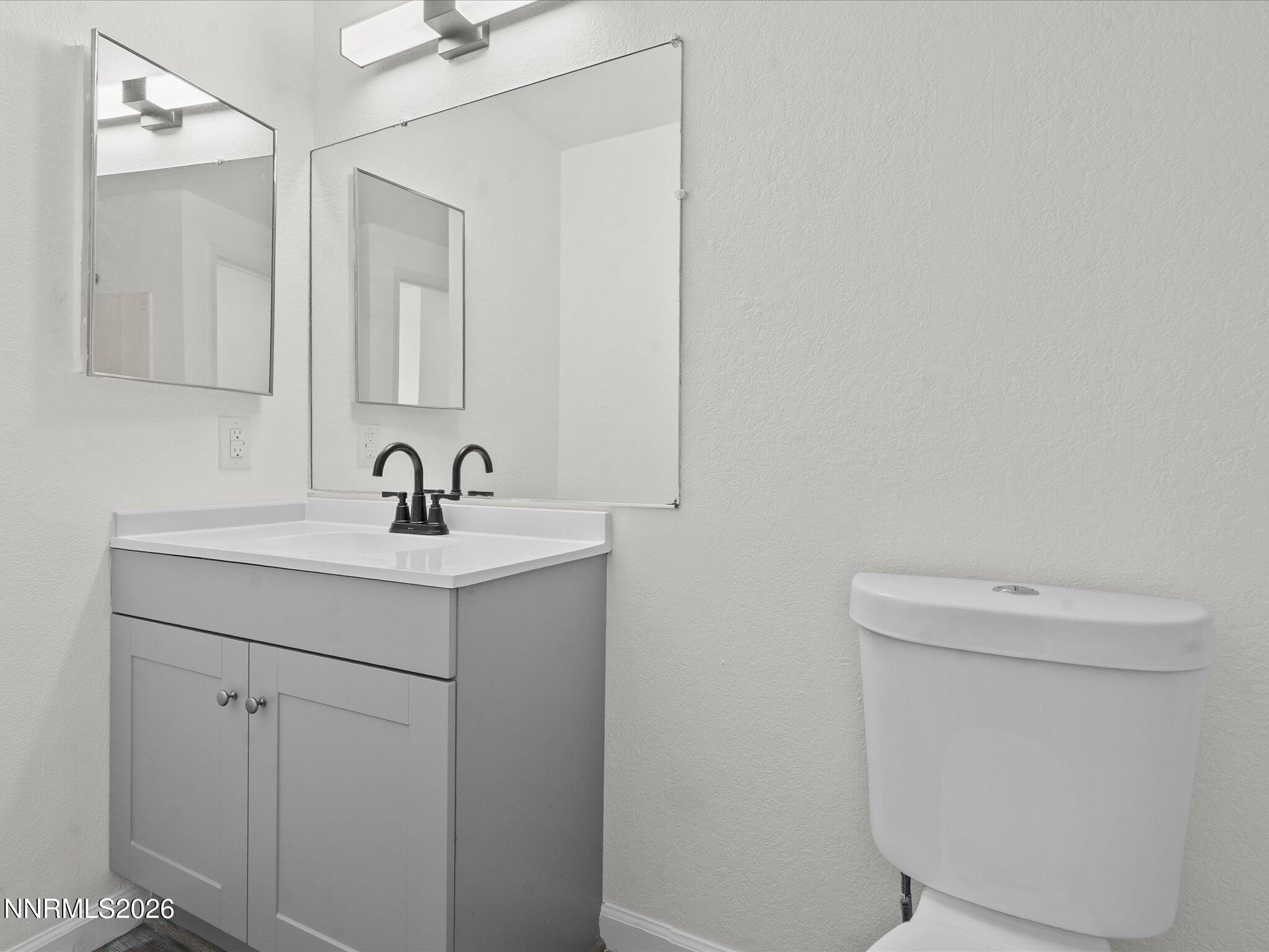 220 Allouette Way, Unit 4 Carson City, NV 89701 - Photo 22 of 22 a bathroom with a sink a toilet and a mirror