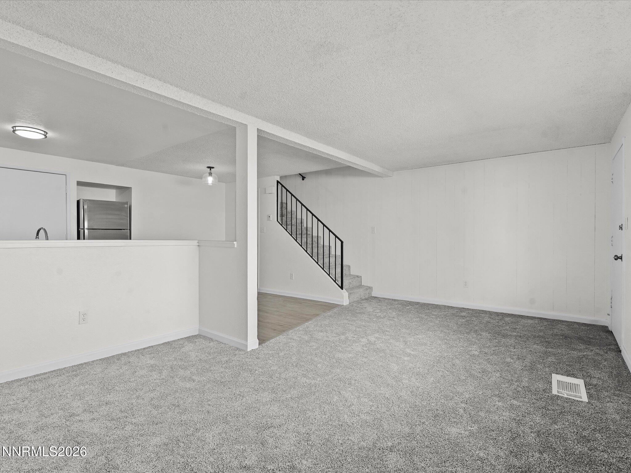 220 Allouette Way, Unit 4 Carson City, NV 89701 - Photo 5 of 22 a view of an empty room with stairs