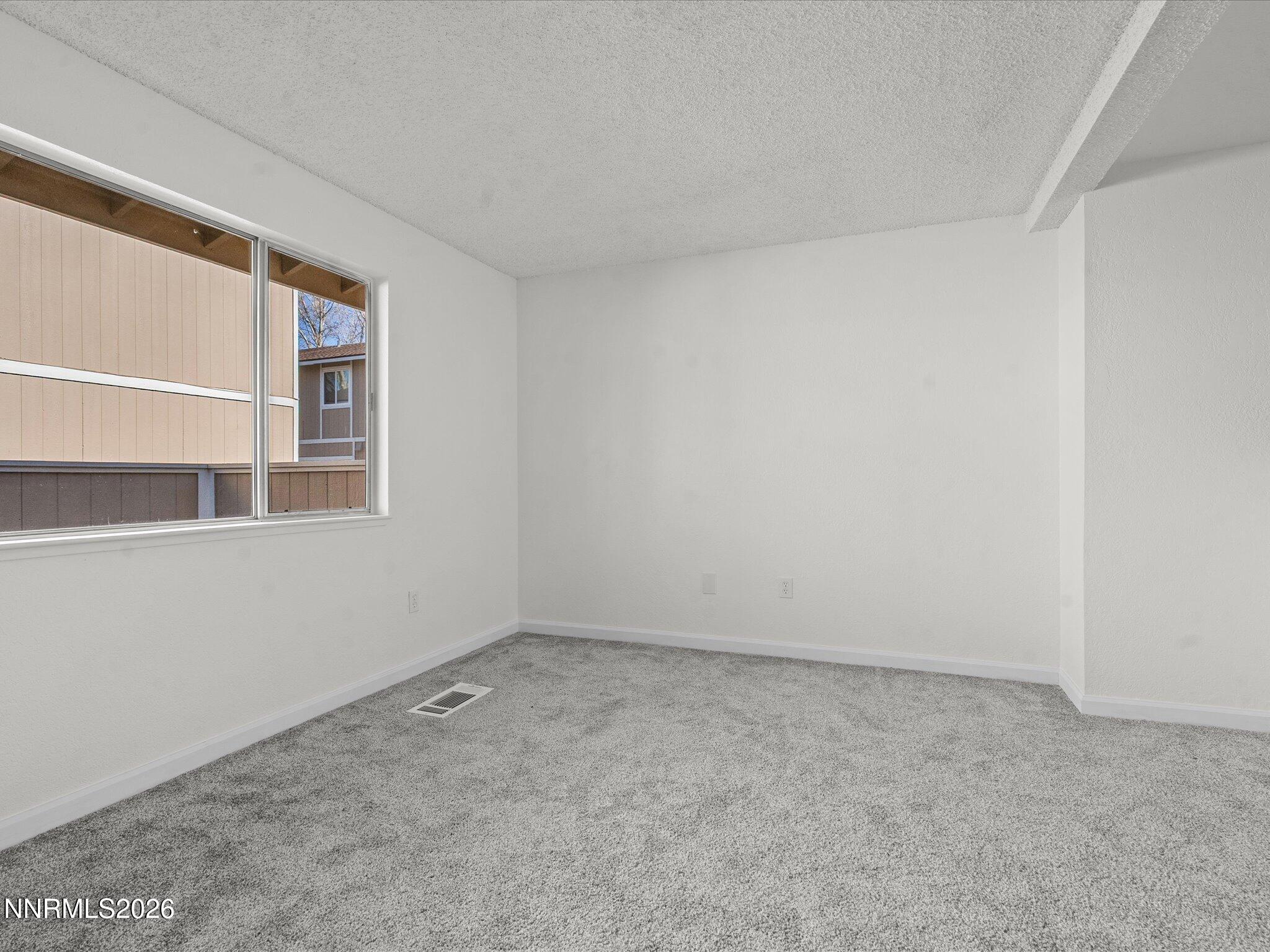 220 Allouette Way, Unit 4 Carson City, NV 89701 - Photo 6 of 22 a view of an empty room with a window