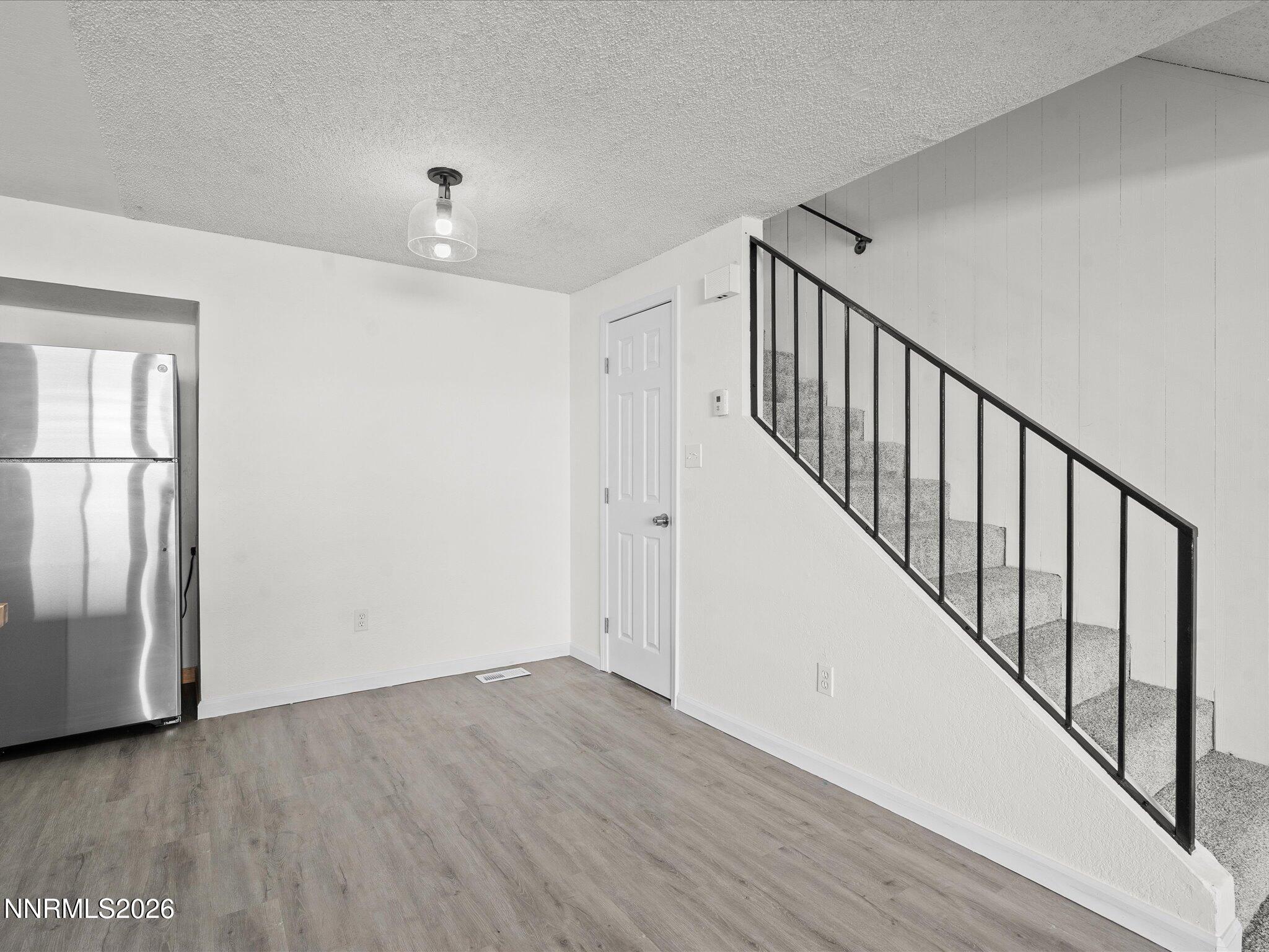220 Allouette Way, Unit 4 Carson City, NV 89701 - Photo 9 of 22 a view of a hallway with wooden floor and entryway