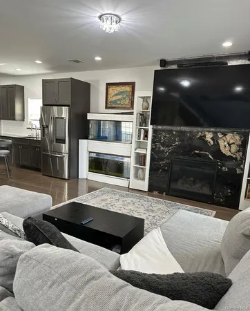 a kitchen with a sink table and chairs
