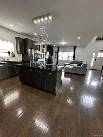 a kitchen with stainless steel appliances granite countertop a sink and stove