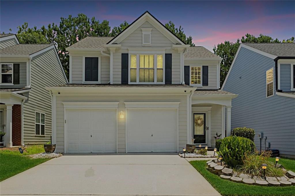 3154 Welmingham Drive Southwest Atlanta, GA 30331 - Photo 1 of 1 a front view of a house with a yard and garage