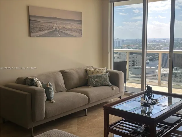 a living room with furniture and a large window