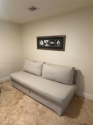 a living room with a couch and a potted plant