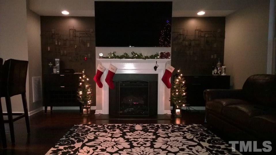 5619 Wade Park Boulevard Raleigh, NC 27607 - Photo 1 of 11 a room with furniture and a fireplace