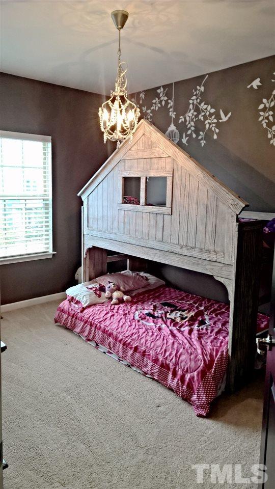 5619 Wade Park Boulevard Raleigh, NC 27607 - Photo 4 of 11 a bedroom with bed and window